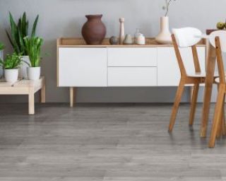 Grey laminate flooring in an open plan dining room
